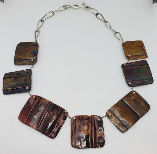 Folded and Textured Copper Shapes with Sterling Silver Chain BoHo Necklace, copyright © Monika Piazza